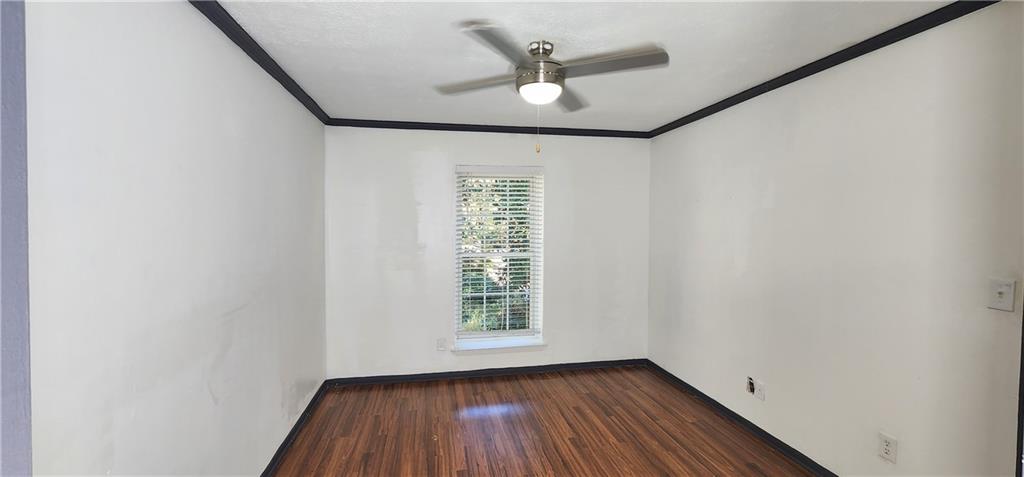 2805 Ne Expressway, Unit B36 Atlanta, GA 30345 - Photo 15 of 29 an empty room with wooden floor chandelier fan and windows
