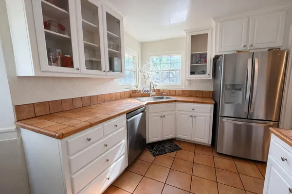 a kitchen with a refrigerator and a sink