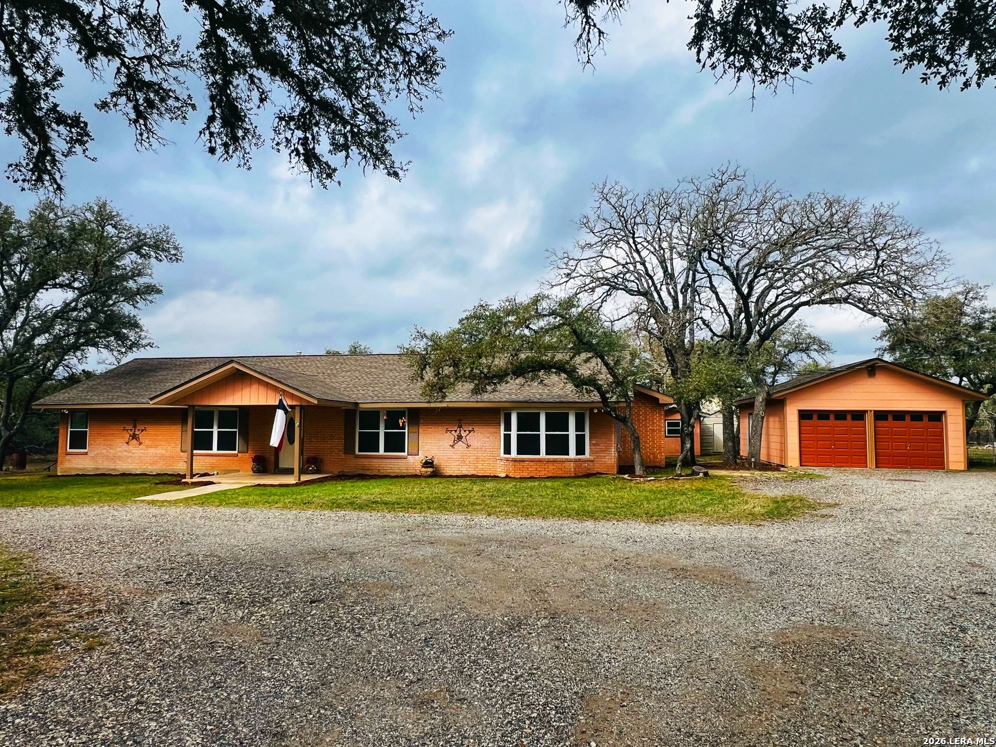 30511 Oakview Road Bulverde, TX 78163 - Photo 1 of 35 a front view of a house with a garden and pathway