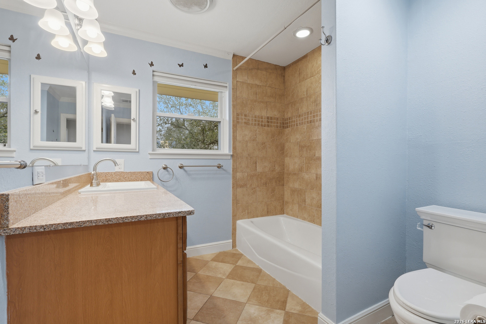 30511 Oakview Road Bulverde, TX 78163 - Photo 13 of 35 a bathroom with a granite countertop sink a toilet a mirror and bathtub