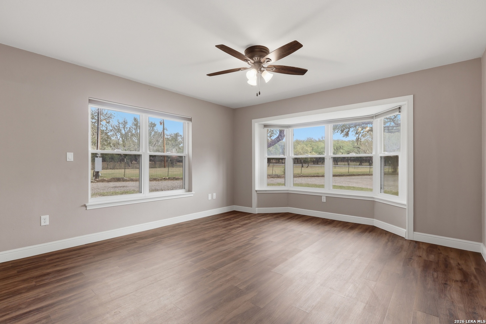 30511 Oakview Road Bulverde, TX 78163 - Photo 19 of 35 a view of an empty room with wooden floor and a window