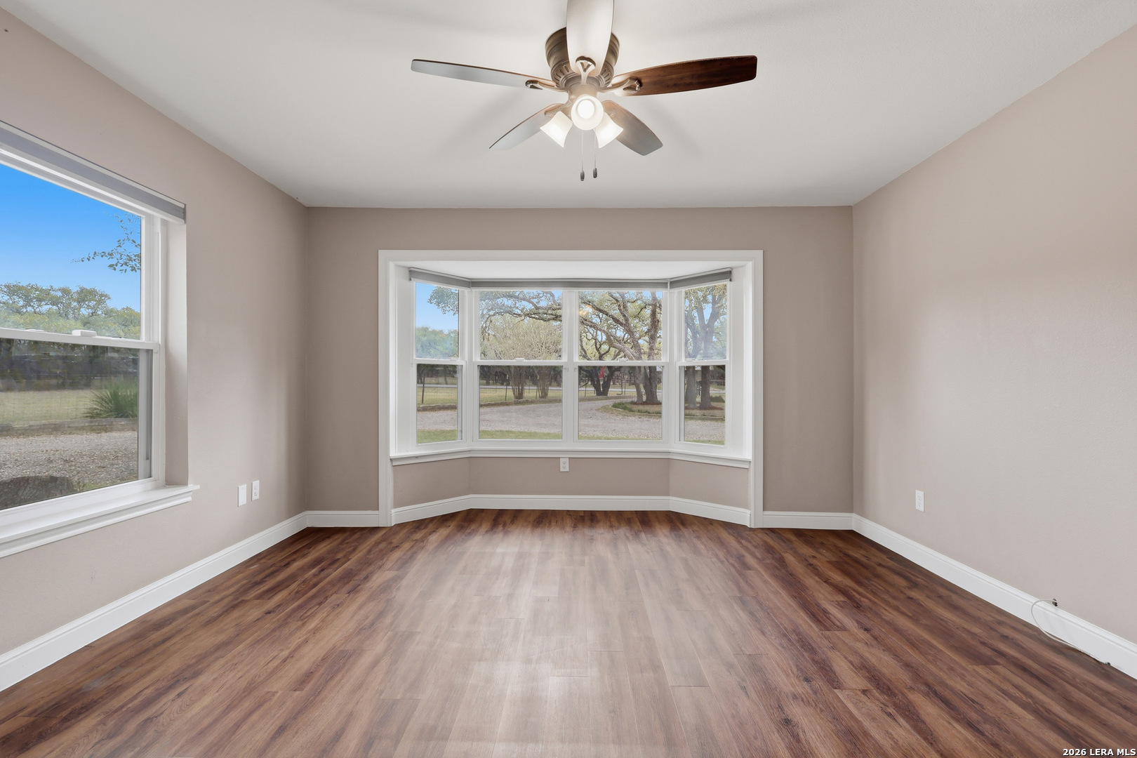 30511 Oakview Road Bulverde, TX 78163 - Photo 20 of 35 a view of room with window ceiling fan and wooden floor