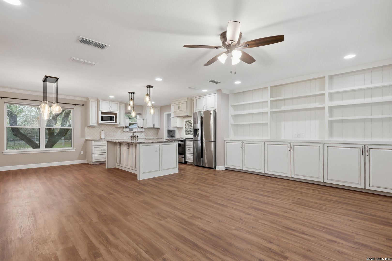 30511 Oakview Road Bulverde, TX 78163 - Photo 5 of 35 a view of a kitchen with wooden floor and a window