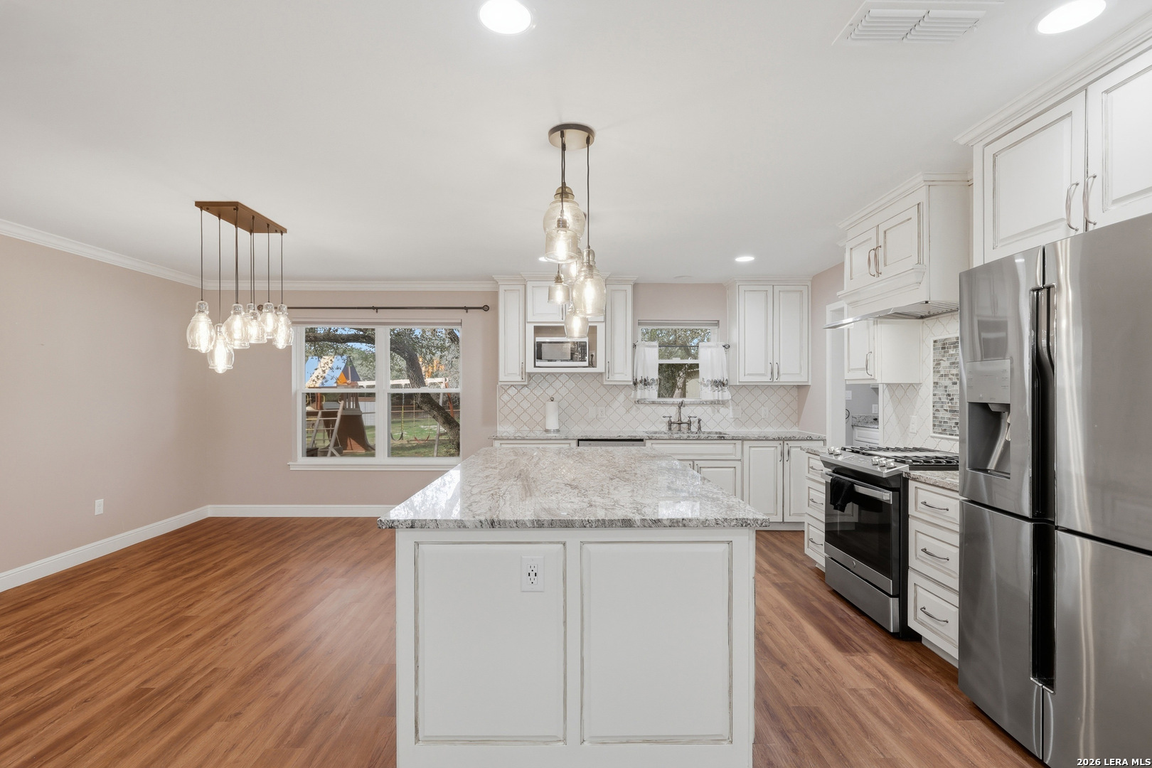 30511 Oakview Road Bulverde, TX 78163 - Photo 7 of 35 a kitchen with stainless steel appliances granite countertop a sink refrigerator and cabinets