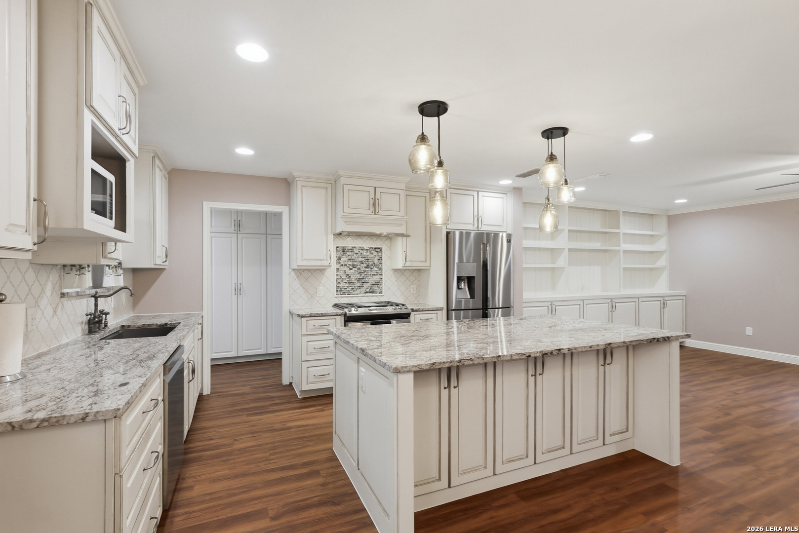 30511 Oakview Road Bulverde, TX 78163 - Photo 8 of 35 a kitchen with stainless steel appliances kitchen island granite countertop a stove and a sink