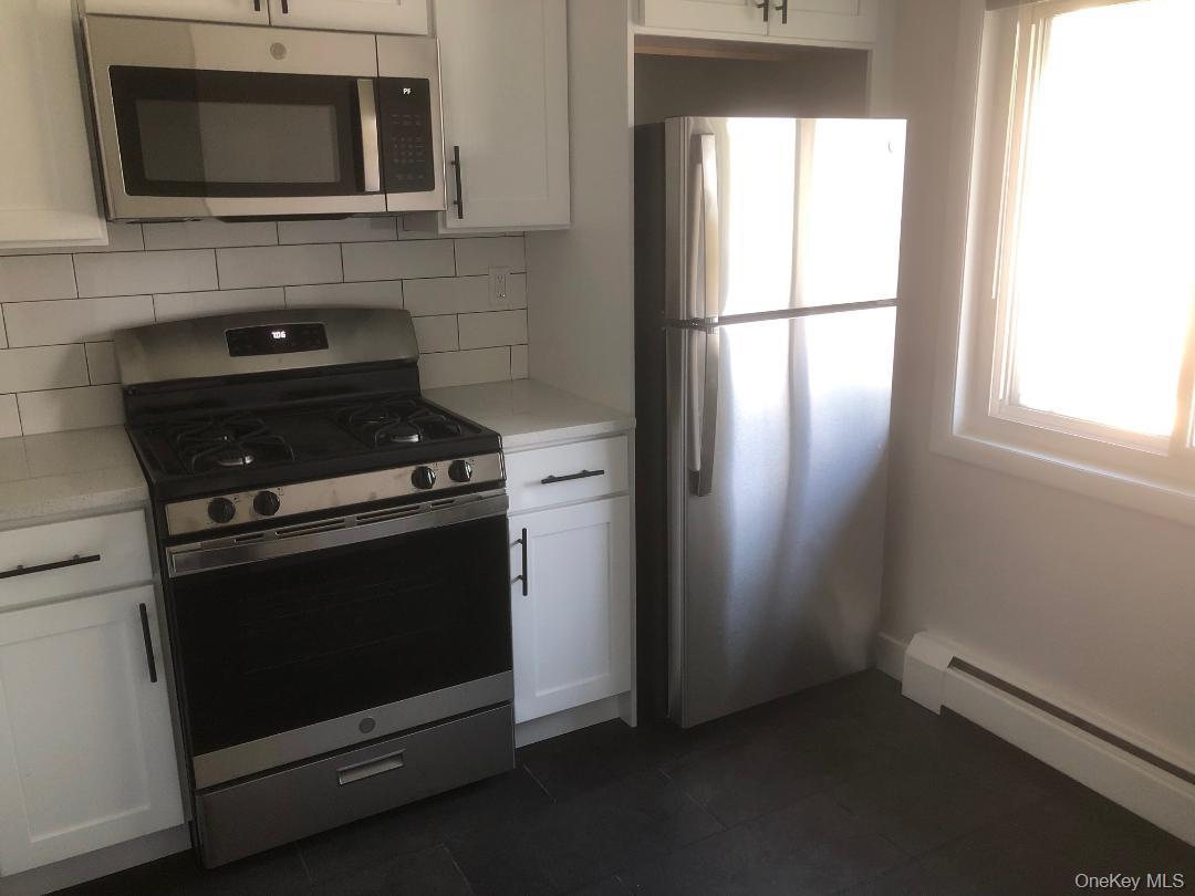 85 North Middletown Road, Unit A7 Nanuet, NY 10954 - Photo 4 of 12 Kitchen featuring stainless steel appliances including a refrigerator, gas range, dishwasher and over-the-range microwave