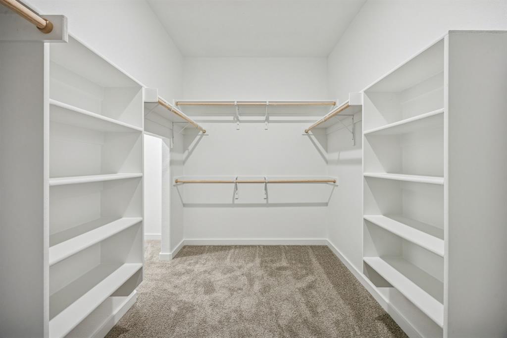 1404 Companero Street Haslet, TX 76052 - Photo 24 of 40 Primary Closet in the Wimbledon home plan by Trophy Signature Homes – REPRESENTATIVE PHOTO