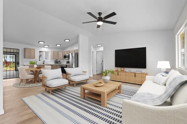a living room with furniture a rug and a flat screen tv