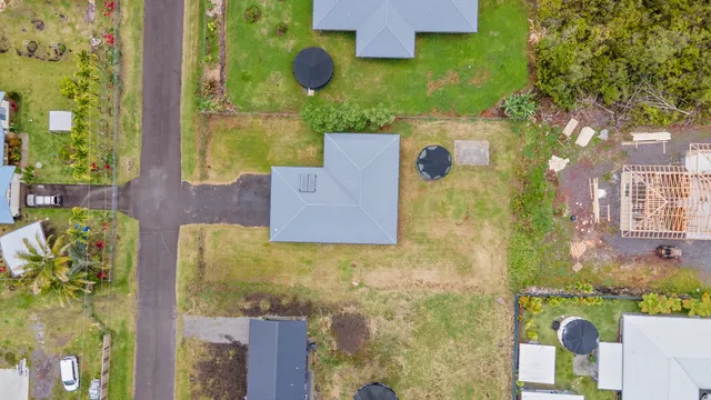 an aerial view of residential houses with outdoor space and swimming pool