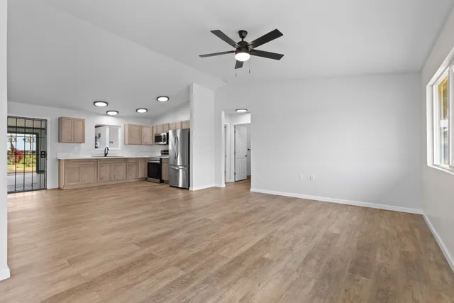 a view of a livingroom with a ceiling fan and window
