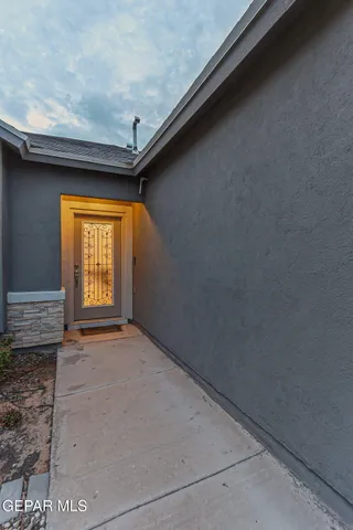 a kitchen with kitchen island granite countertop a sink stove and white cabinets
