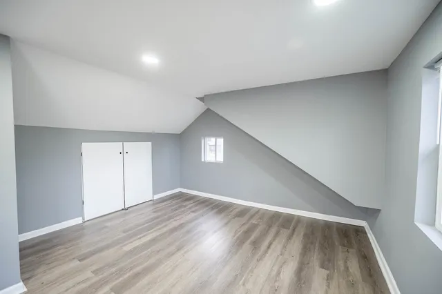 a view of empty room with wooden floor