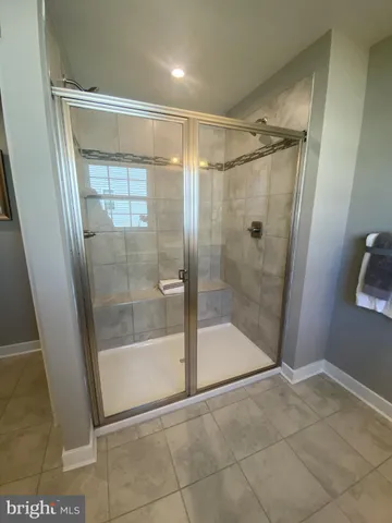 a spacious bedroom with a bed and wooden floor