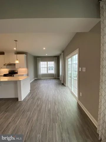 a view of kitchen and hall with wooden floor