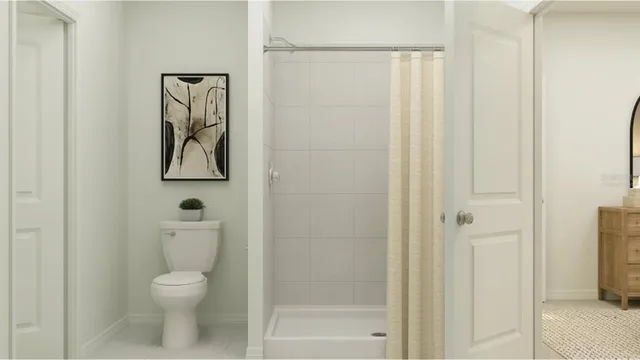 a bathroom with a toilet and a shower
