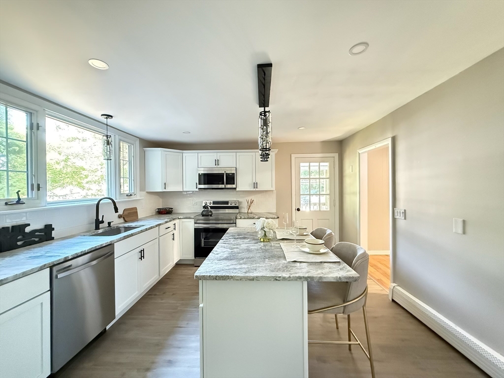 37 Bridge Street Monson, MA 01057 - Photo 4 of 35 a kitchen with sink a stove and cabinets