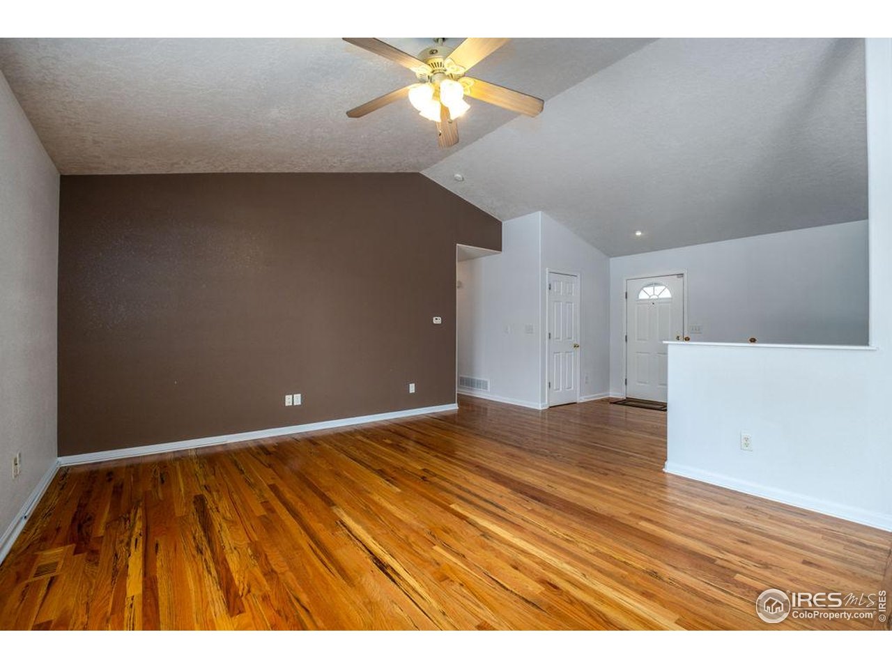 1743 68th Avenue Greeley, CO 80634 - Photo 11 of 30 a view of an empty room and cabinet with a ceiling fan