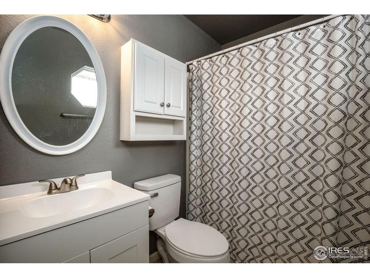 1743 68th Avenue Greeley, CO 80634 - Photo 12 of 30 a bathroom with a sink and a mirror