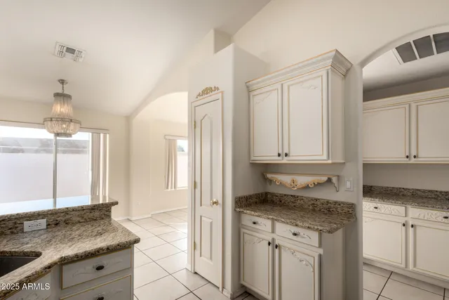 a kitchen with granite countertop a sink and cabinets