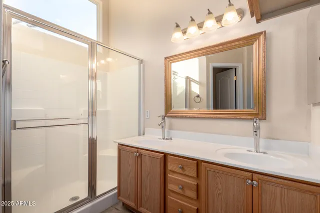 a bathroom with a double vanity sink and a mirror