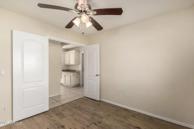 wooden floor in an empty room and a bathroom