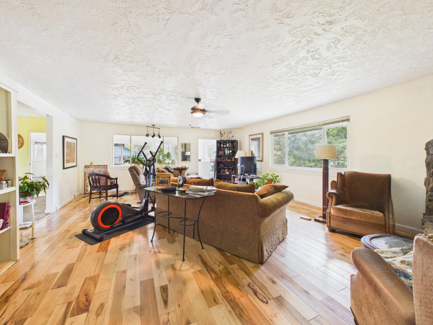 37777 China Creek Road Oakhurst, CA 93644 - Photo 12 of 64 a living room with furniture a rug and a flat screen tv