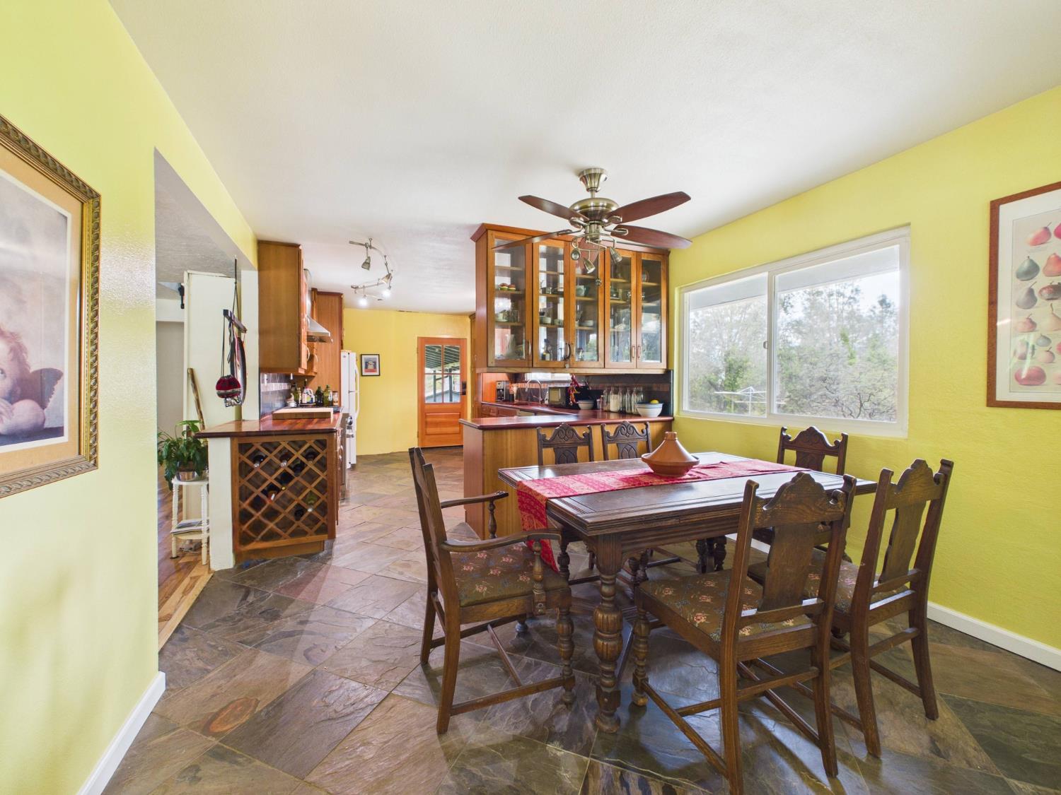 37777 China Creek Road Oakhurst, CA 93644 - Photo 17 of 64 a dining room with furniture a rug and a large window