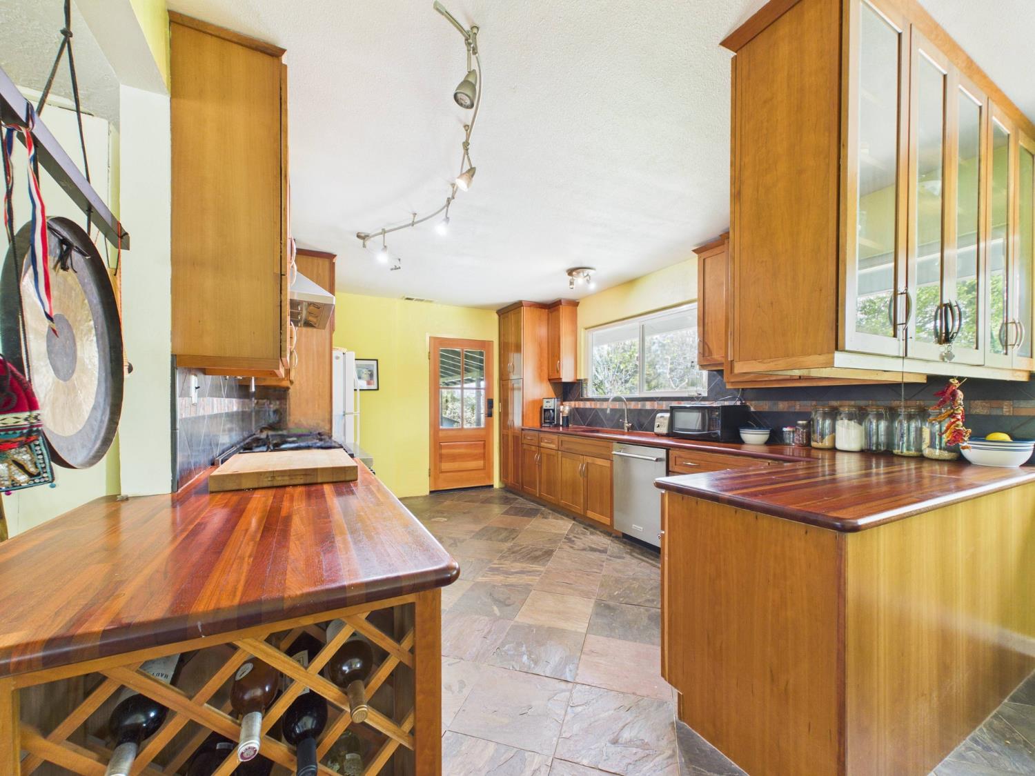 37777 China Creek Road Oakhurst, CA 93644 - Photo 20 of 64 a kitchen with stainless steel appliances granite countertop a sink and cabinets