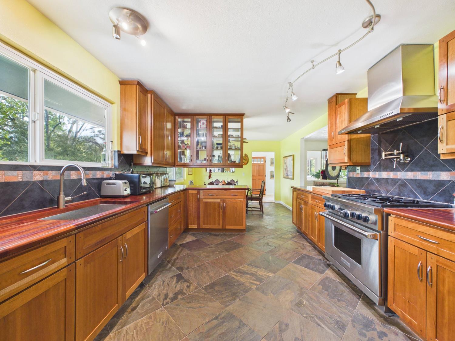 37777 China Creek Road Oakhurst, CA 93644 - Photo 21 of 64 a kitchen with stainless steel appliances granite countertop a stove and a sink