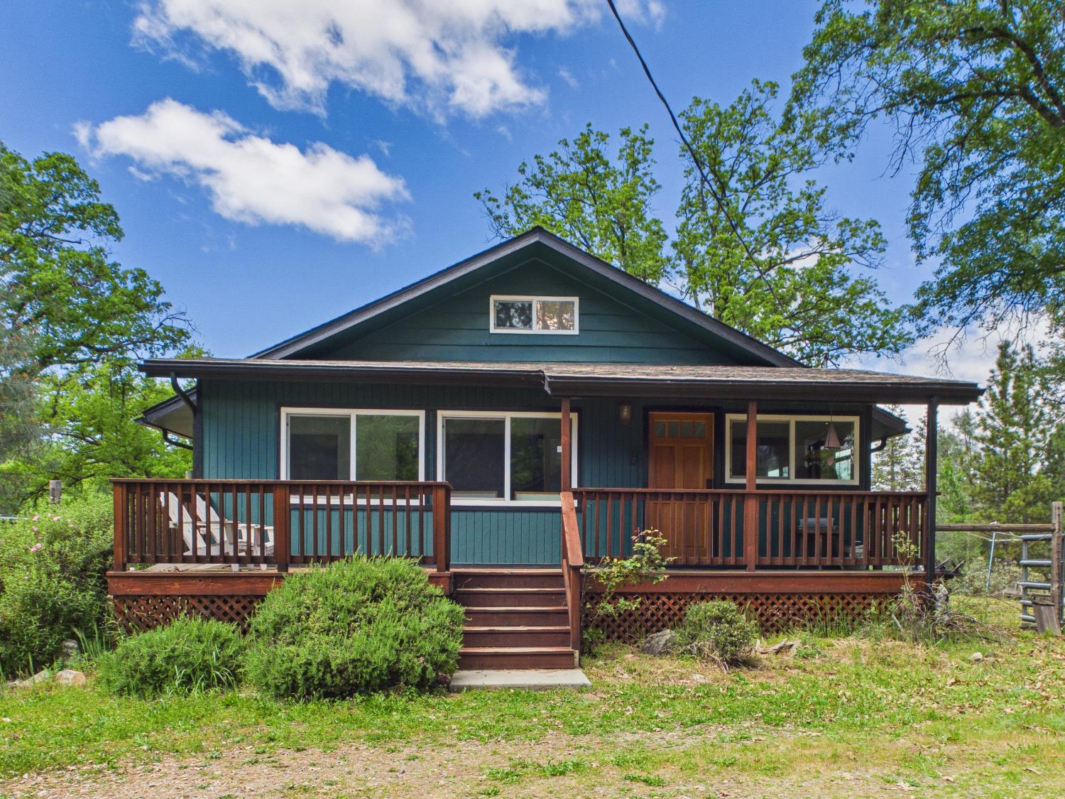 37777 China Creek Road Oakhurst, CA 93644 - Photo 3 of 64 a front view of a house with yard and deck