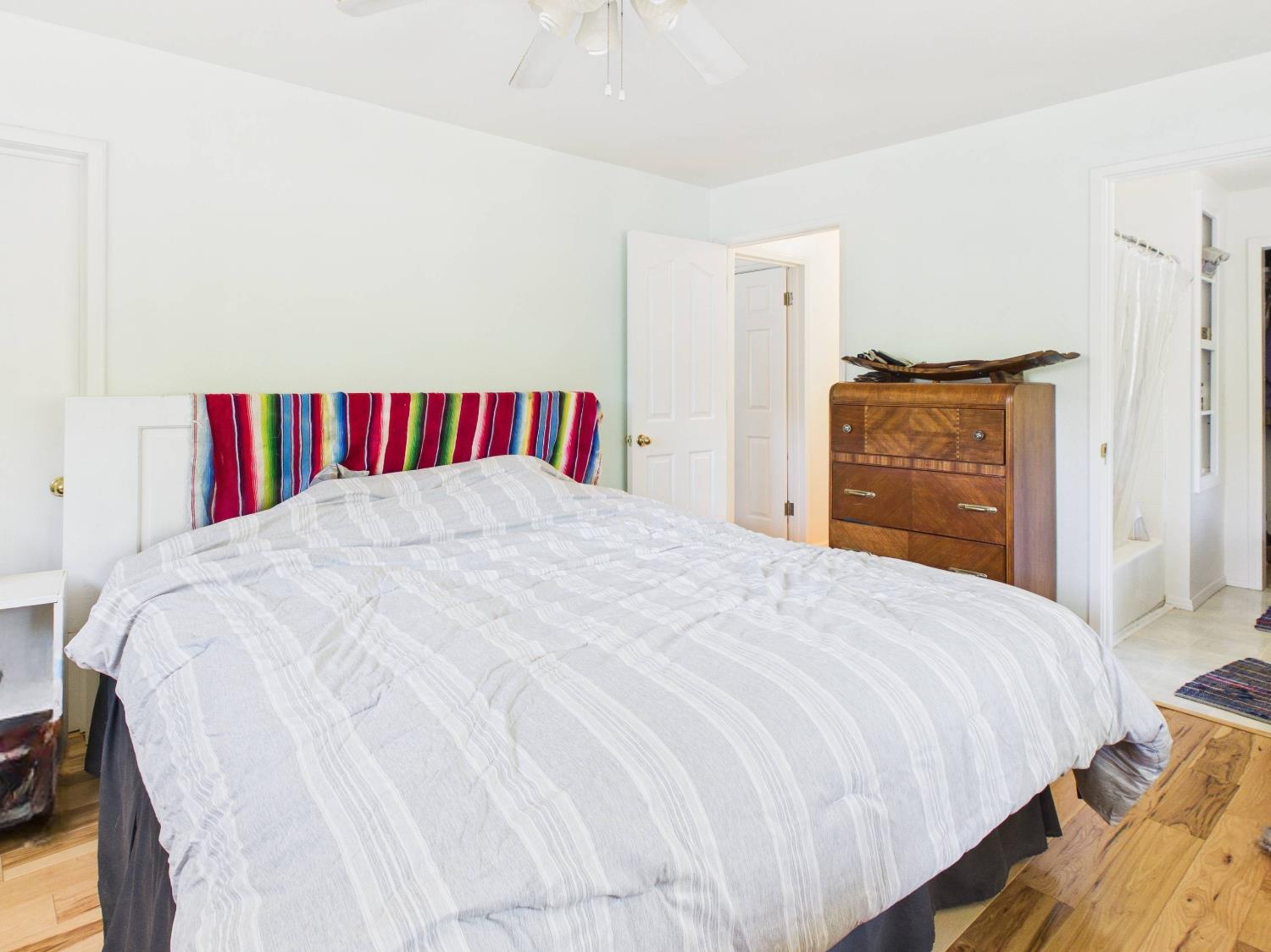 37777 China Creek Road Oakhurst, CA 93644 - Photo 31 of 64 a large bed sitting in a bedroom chandelier