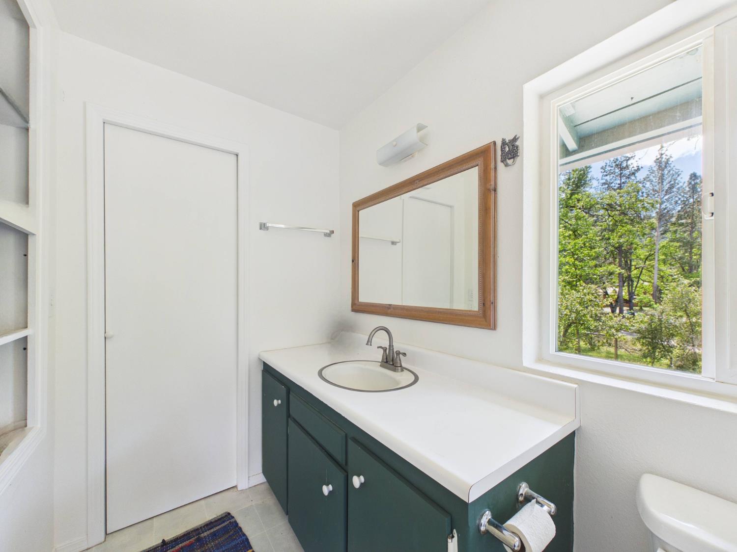 37777 China Creek Road Oakhurst, CA 93644 - Photo 33 of 64 a bathroom with a sink vanity and a mirror