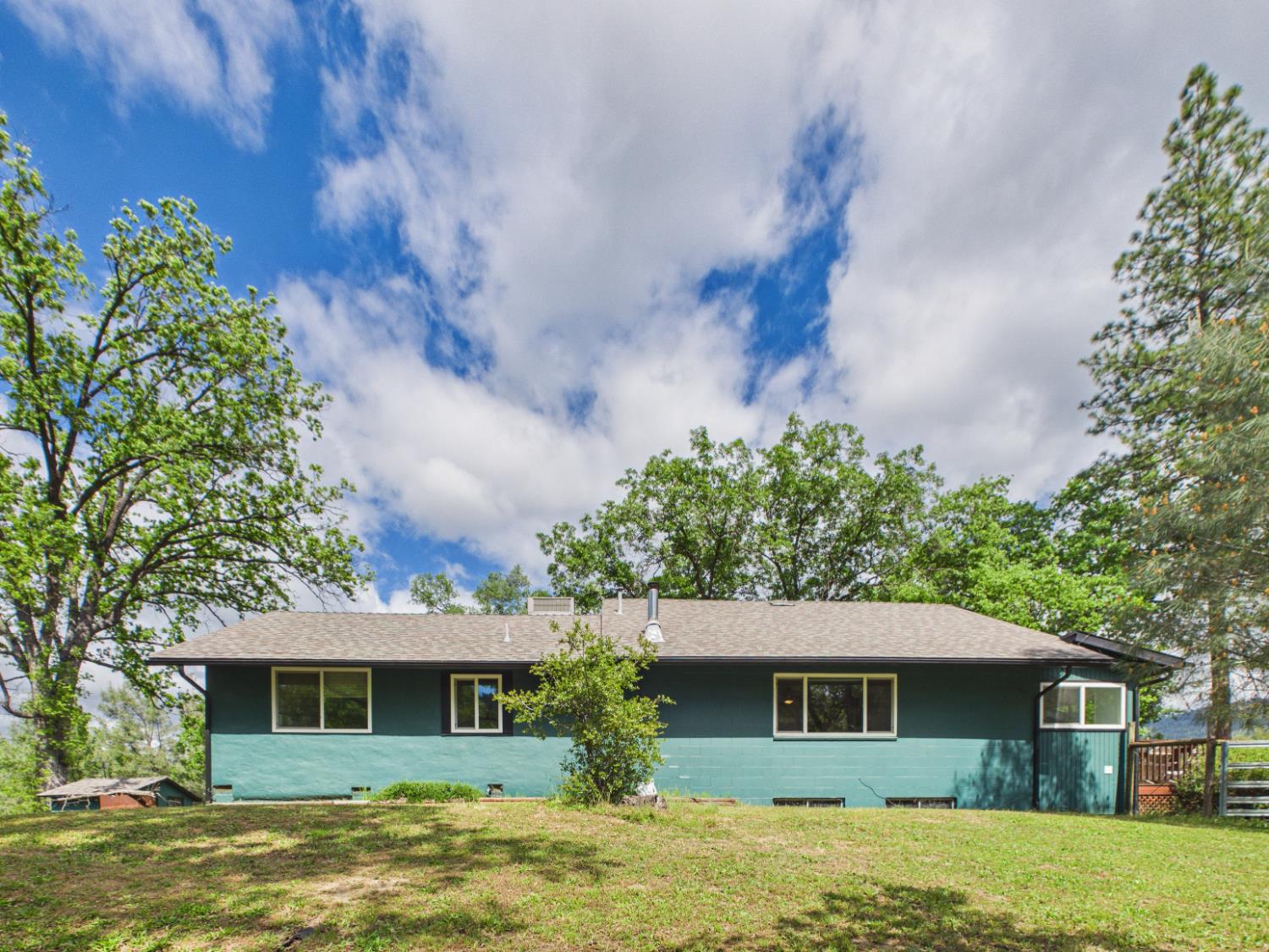 37777 China Creek Road Oakhurst, CA 93644 - Photo 50 of 64 a front view of a house with a garden