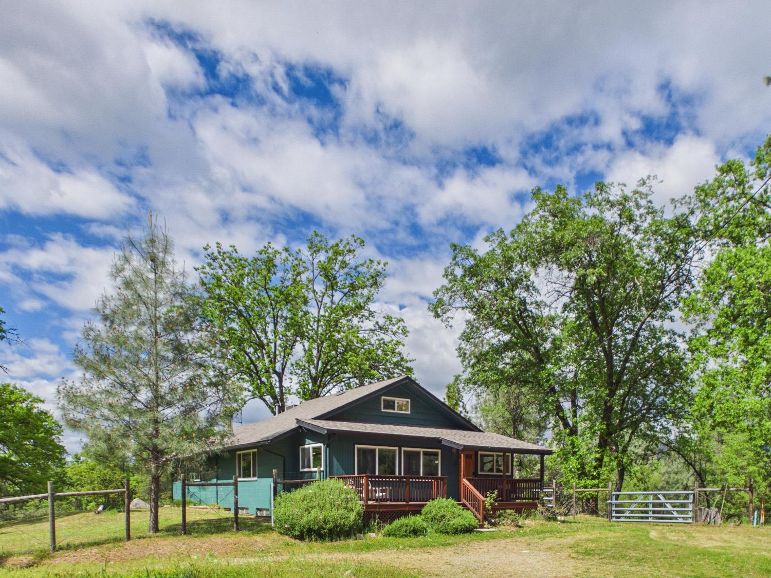 37777 China Creek Road Oakhurst, CA 93644 - Photo 60 of 64 a front view of a house with a garden