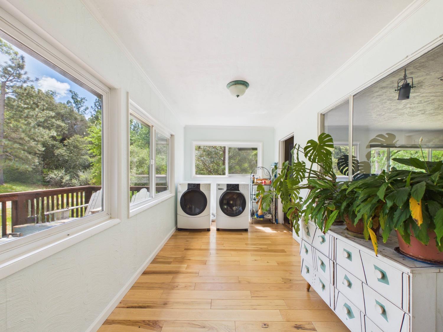37777 China Creek Road Oakhurst, CA 93644 - Photo 8 of 64 a balcony with wooden floor outdoor seating and yard