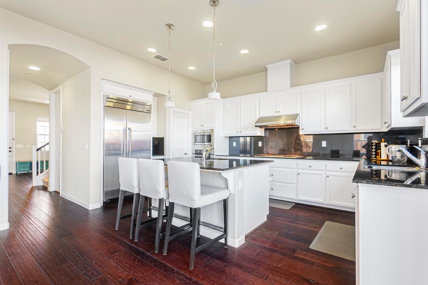 1875 Worthington Circle Santa Clara, CA 95050 - Photo 8 of 39 a kitchen with white cabinets and stainless steel appliances