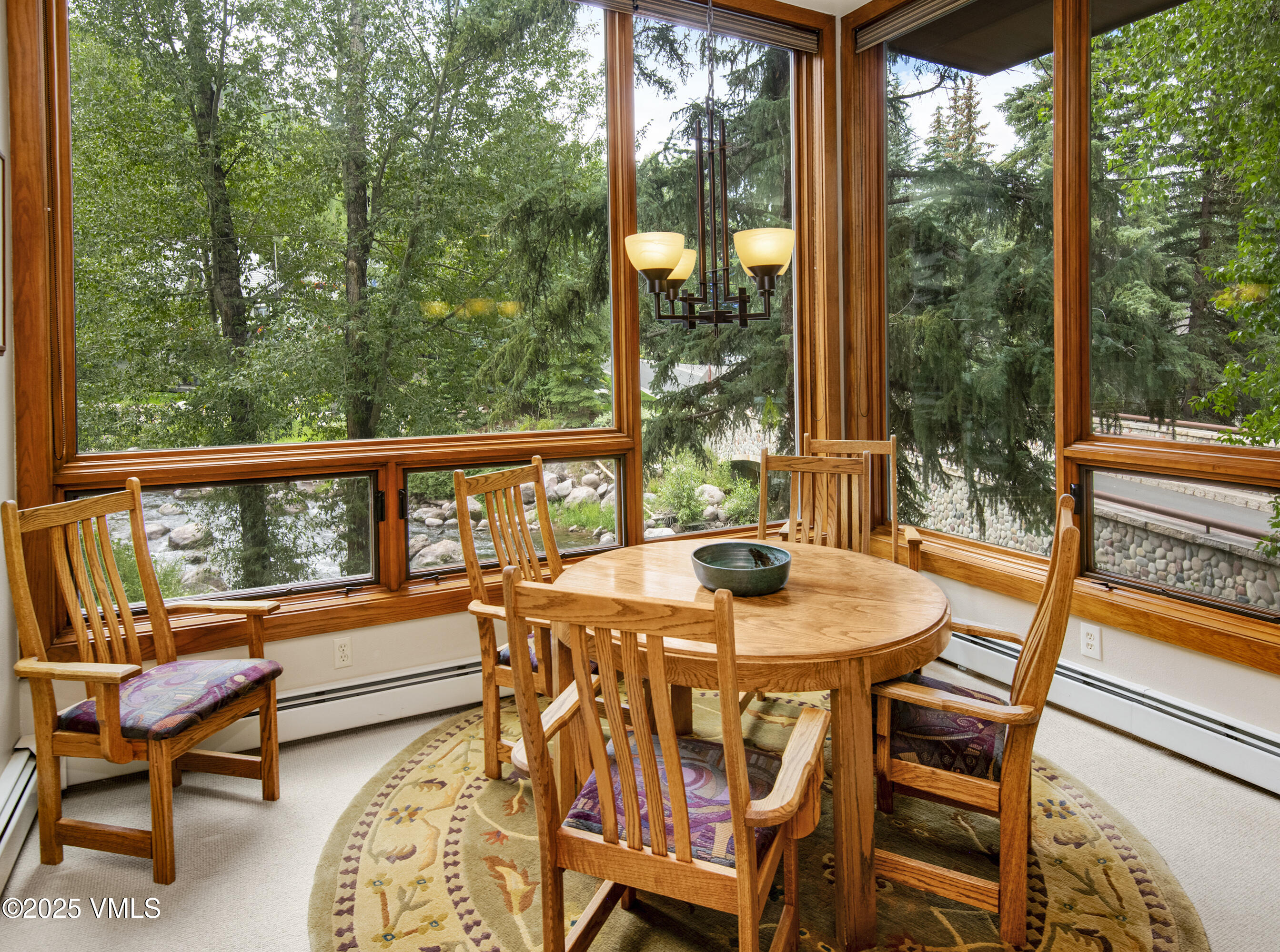 1360 Westhaven Drive, Unit 5A Vail, CO 81657 - Photo 15 of 60 a view of a patio with a table chairs and a backyard
