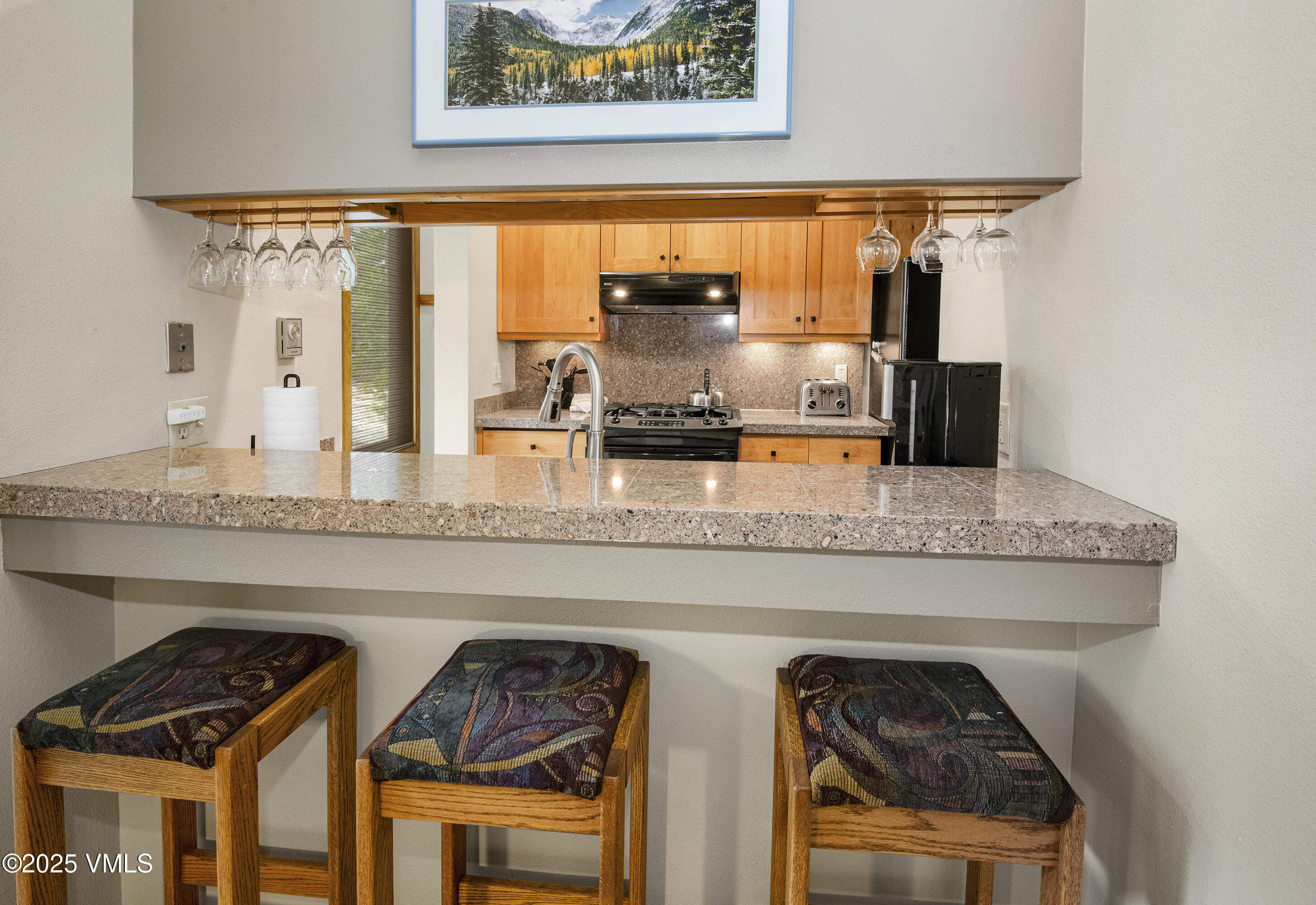 1360 Westhaven Drive, Unit 5A Vail, CO 81657 - Photo 21 of 60 a kitchen with stainless steel appliances granite countertop a stove and a wooden cabinets