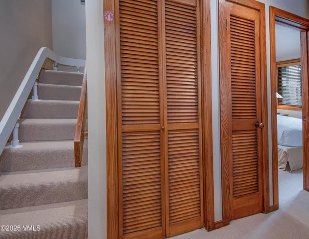 a bedroom with a large bed and a lamp on table