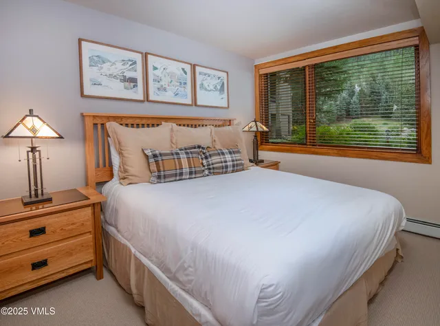 a bedroom with a bed and a lamp