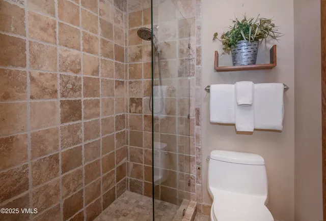 a front view of a house with a yard and potted plants