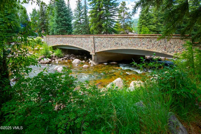 a view of house with a yard and sitting area