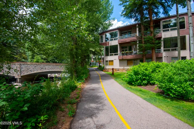 an aerial view of a house with a yard and fountain