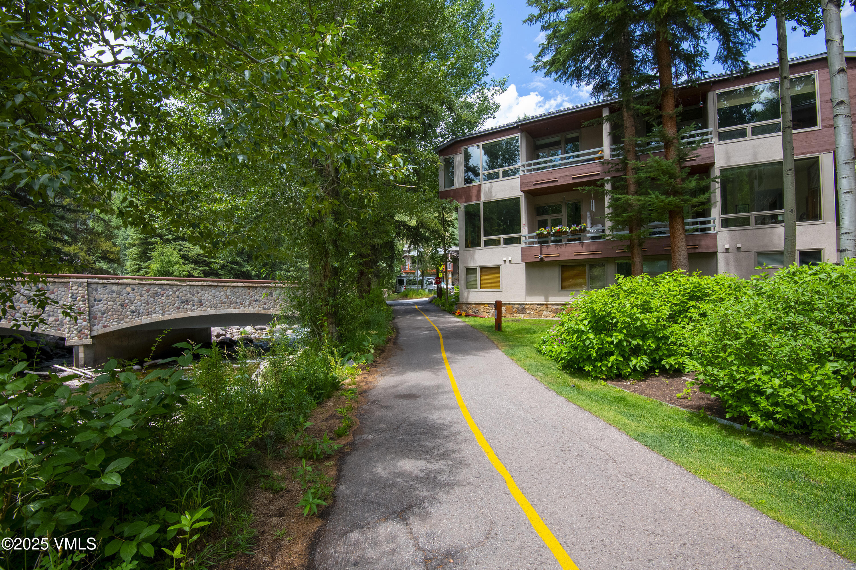 1360 Westhaven Drive, Unit 5A Vail, CO 81657 - Photo 42 of 60 a front view of a house with a yard and potted plants