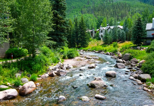 a backyard of a house with a yard and outdoor seating