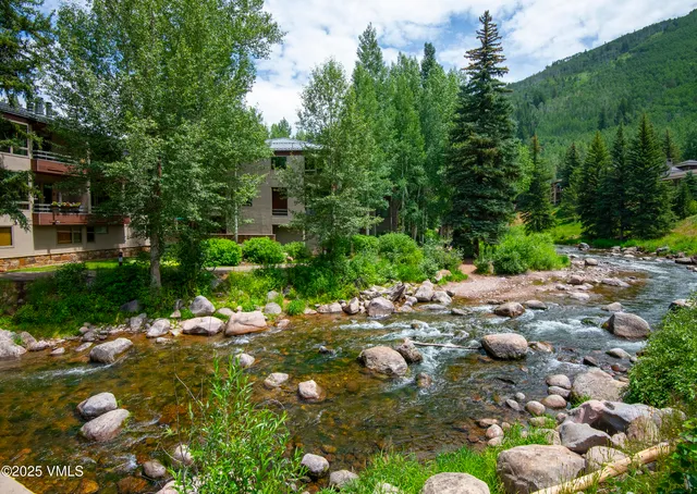a backyard of a house with yard and outdoor seating