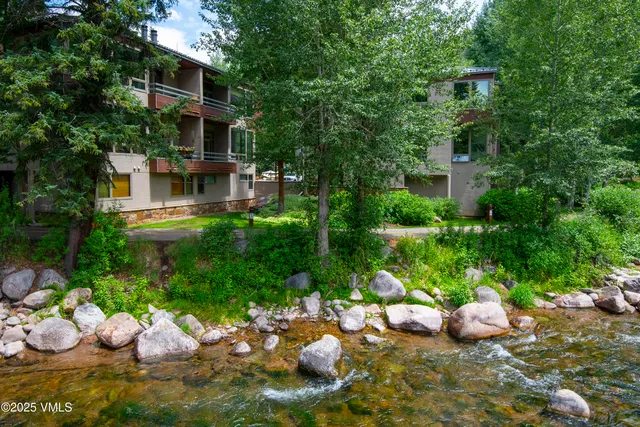 a front view of a house with yard and green space