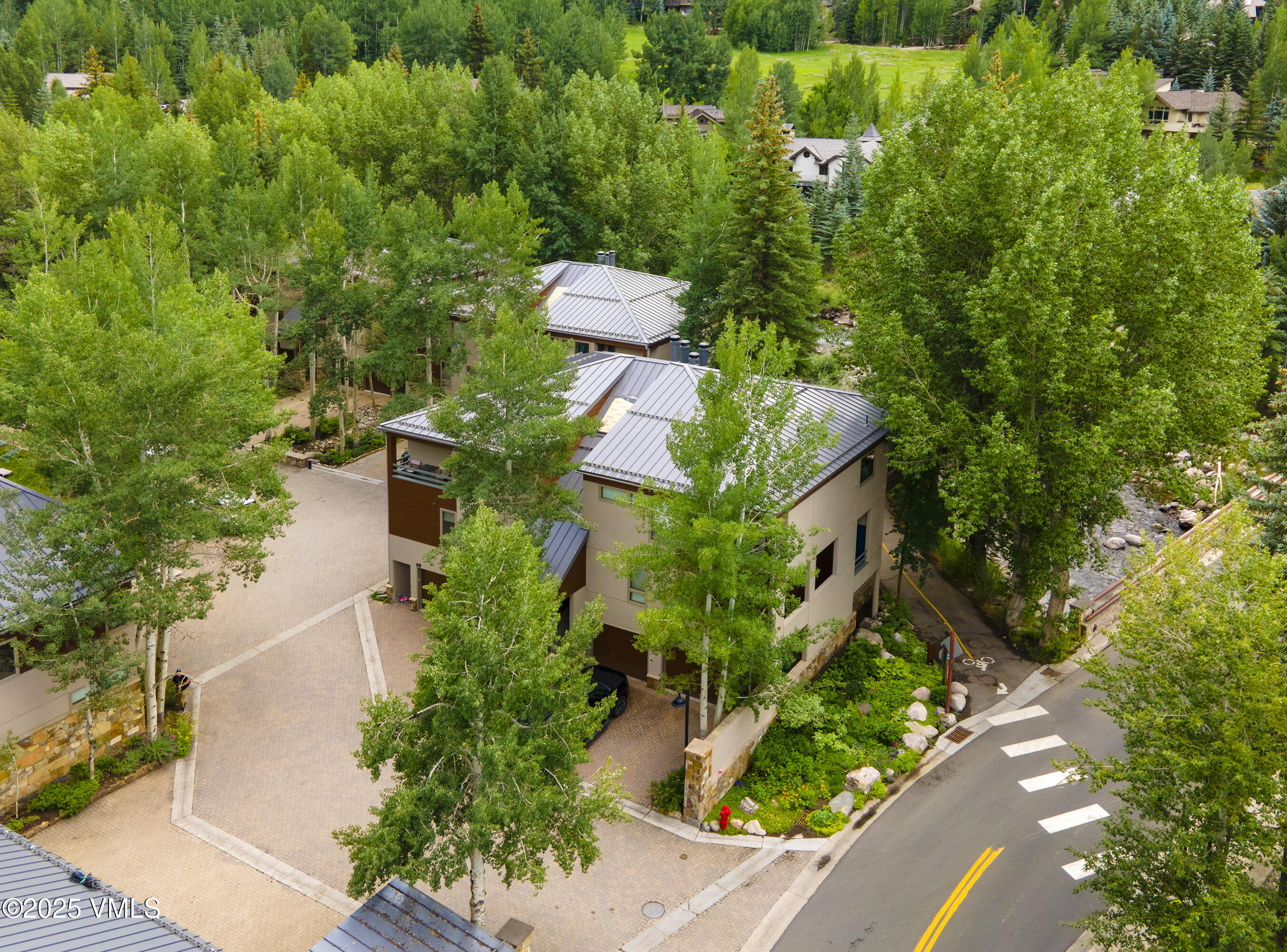 1360 Westhaven Drive, Unit 5A Vail, CO 81657 - Photo 49 of 60 an aerial view of a house with a yard and fountain