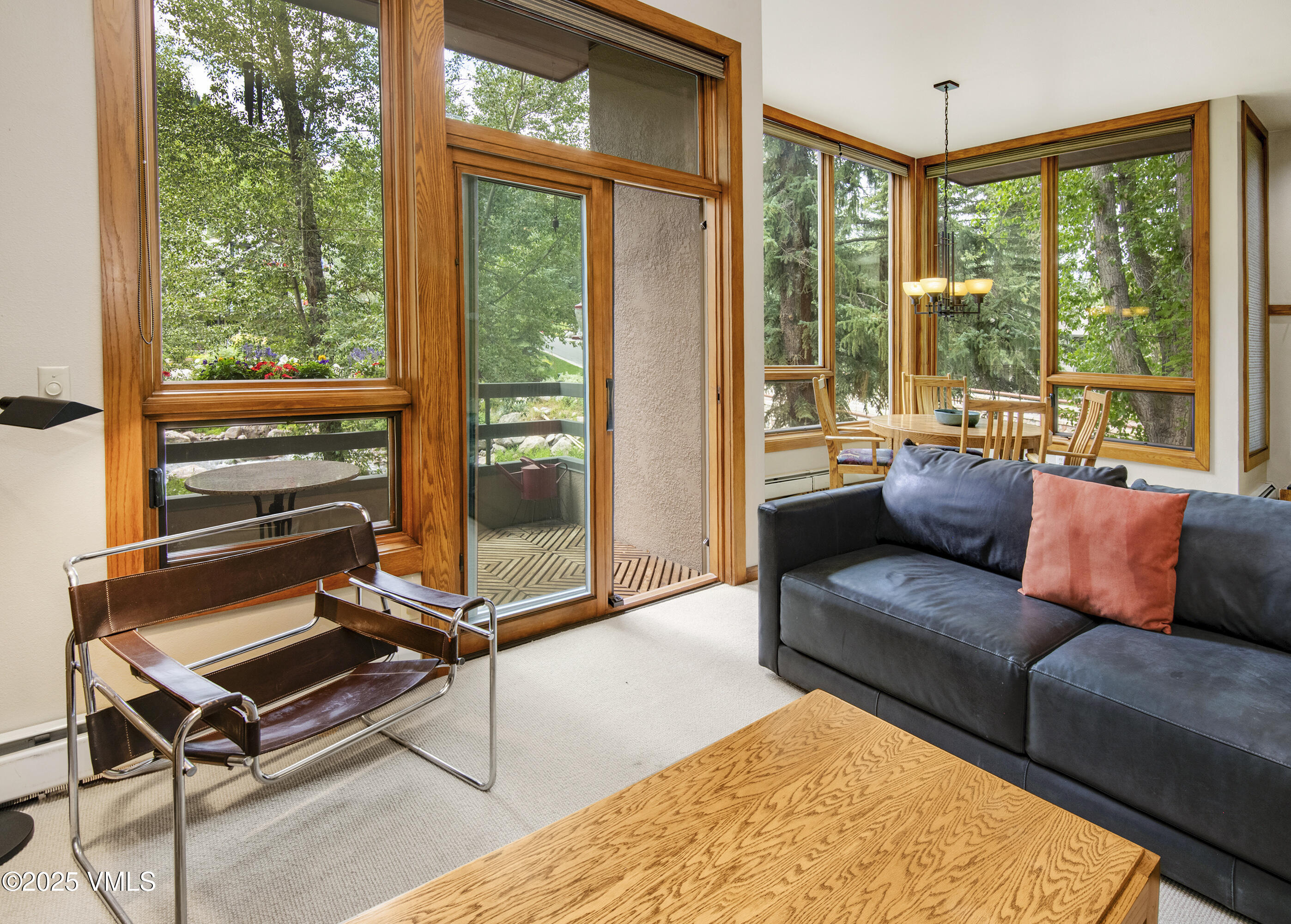 1360 Westhaven Drive, Unit 5A Vail, CO 81657 - Photo 6 of 60 a living room with furniture and a floor to ceiling window