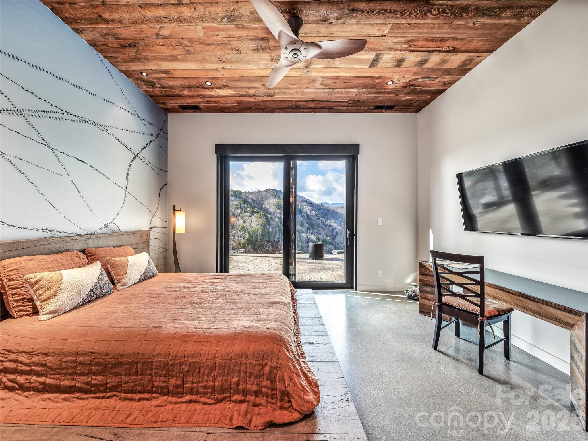 112 Moon Shadow Lane Marshall, NC 28753 - Photo 33 of 48 a bedroom with a bed a table and chair